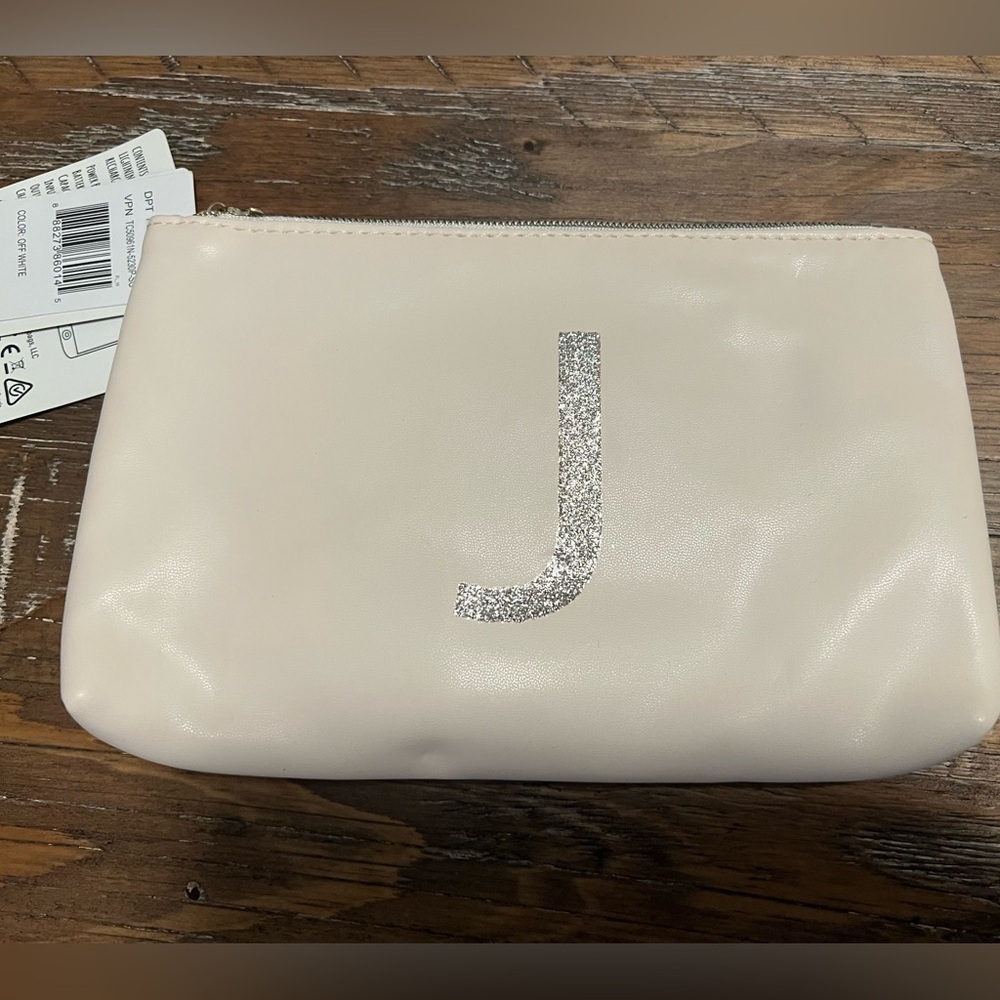 Jade & Deer charging wallet off white with a sparkly J and tassel zipper open